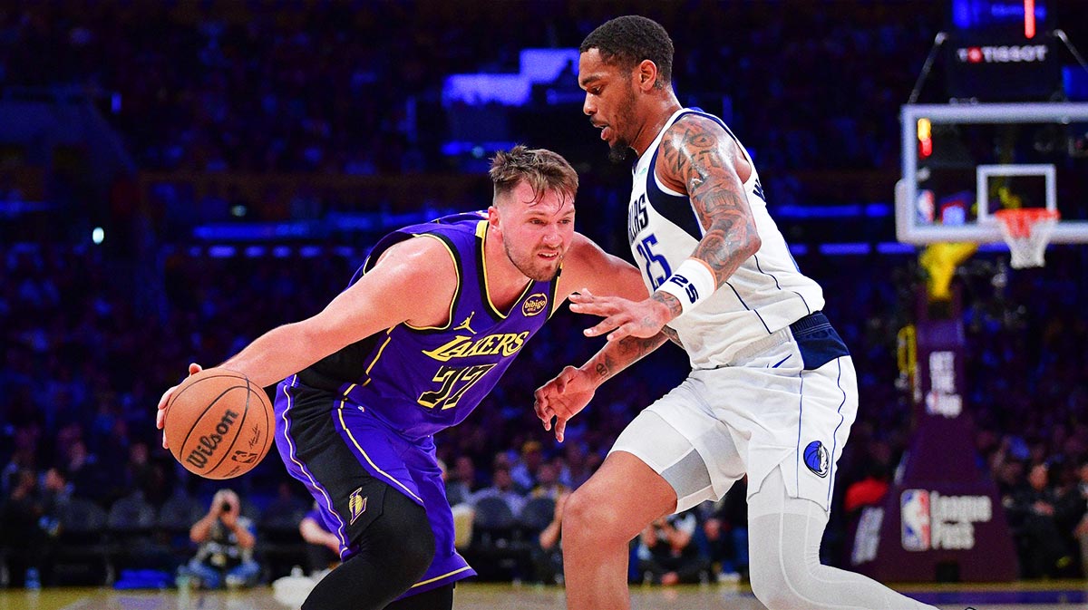 Los Angeles Lakers guard Luka Doncic (77) dribbles the ball against Dallas Mavericks forward P.J. Washington (25) during the second half at Crypto.com Arena.