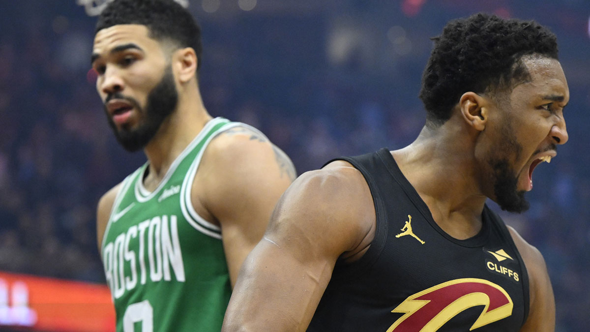 Cleveland Cavaliers guard Donovan Mitchell (45) celebrates beside Boston Celtics forward Jayson Tatum (0) in the first quarter at Rocket Mortgage FieldHouse.