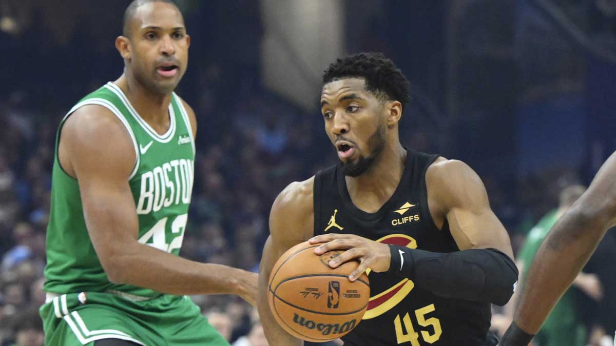 Cleveland Cavaliers guard Donovan Mitchell (45) dribbles beside Boston Celtics center Al Horford (42) in the first quarter at Rocket Mortgage FieldHouse.