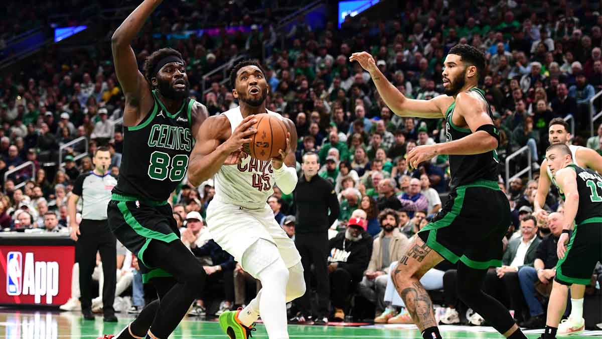 Cleveland Cavaliers Guard Donovan Mitchell (45) Drive to the basket between the Boston Celtics Center NeeMias Queta (88) and Next Jaison Tatum (0) during the second half in the TD garden.