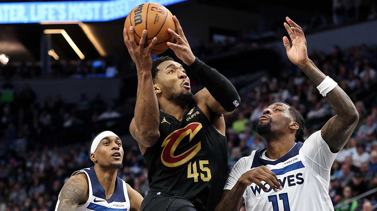 Cleveland Cavaliers Guard Donovan Mitchell (45) Shooting as Minnesota Timbervolves Center Naz Reid (11) Defend during the fourth quarter at the target center.