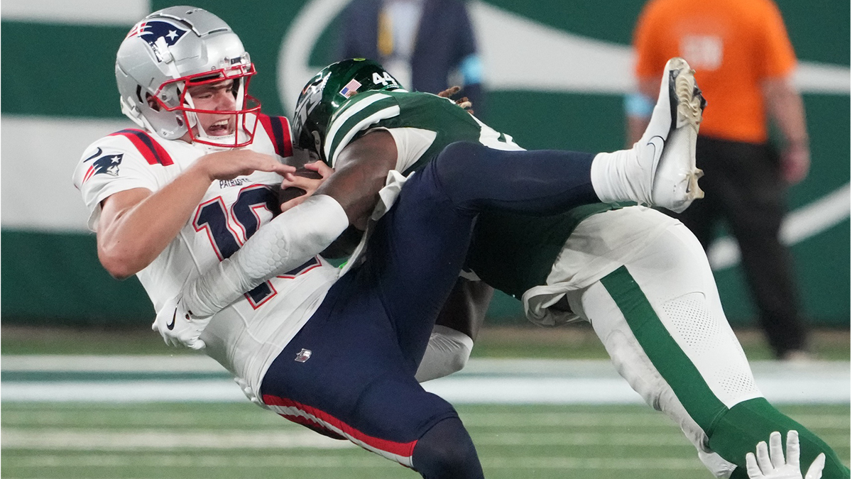 Sep 19, 2024; East Rutherford, New Jersey, USA; New England Patriots quarterback Drake Maye (10) gets sacked hard by New York Jets linebacker Jamien Sherwood (44) in the 4th quarter at MetLife Stadium. Mandatory Credit: Robert Deutsch-Imagn Images