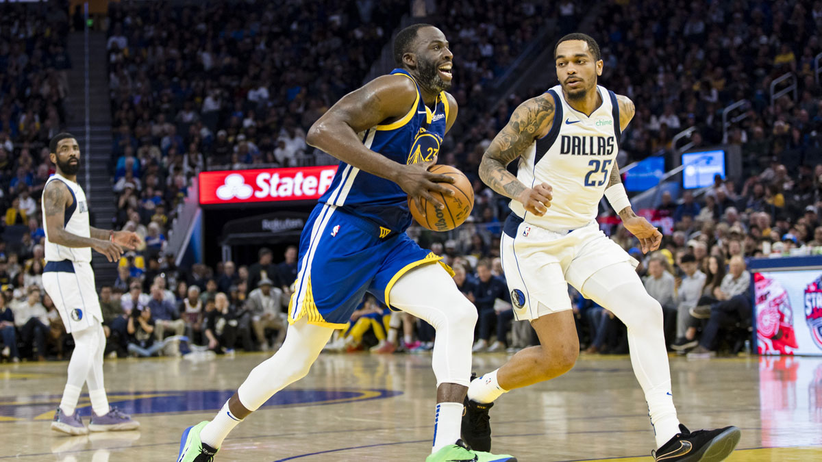 Golden State Warriors forward Draymond Green (23) drives past Dallas Mavericks forward P.J. Washington (25) during the third quarter at Chase Center. 