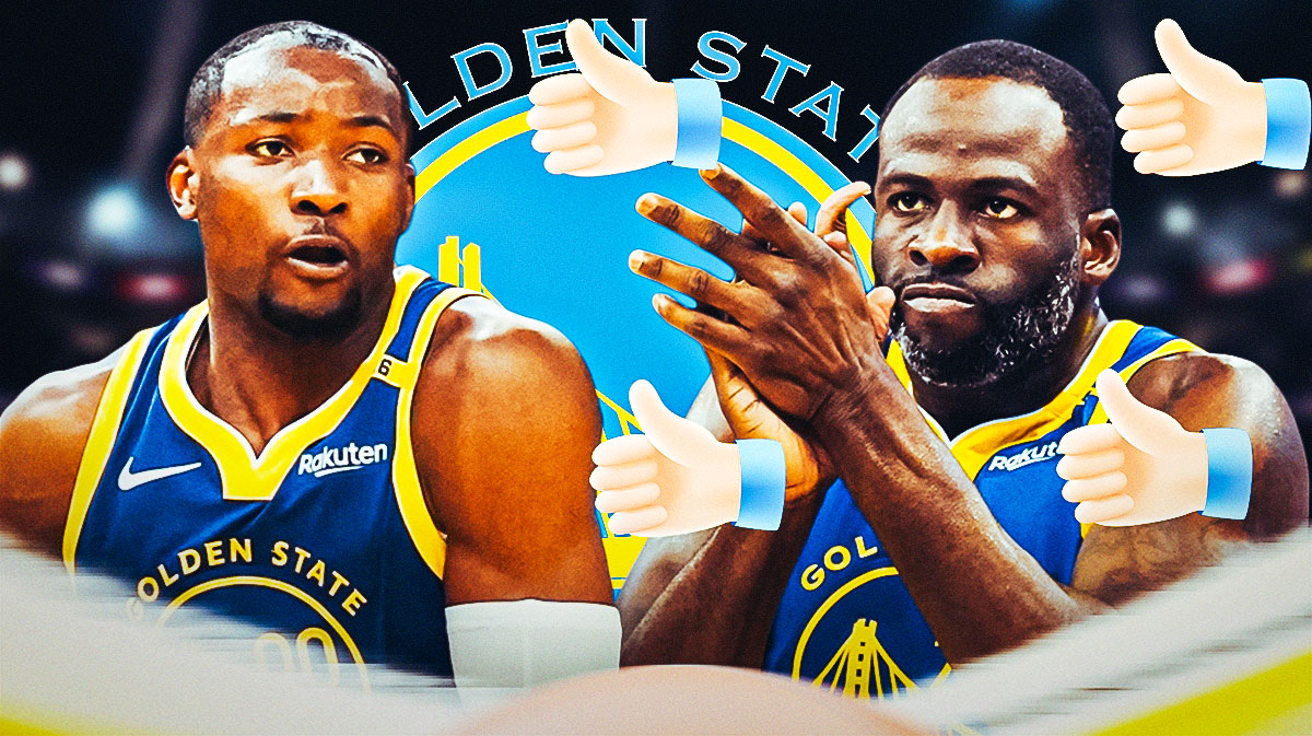 Draymond Green giving a thumbs up to Jonathan Kuminga with the Warriors logo in the background.