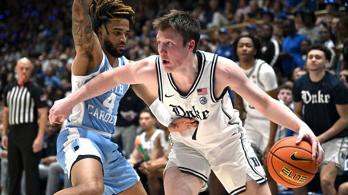 Duke Blue Devils forward Kon Knueppel (7) drives the ball around North Carolina Tar Heels guard R.J. Davis (4) during the second half at Cameron Indoor Stadium.