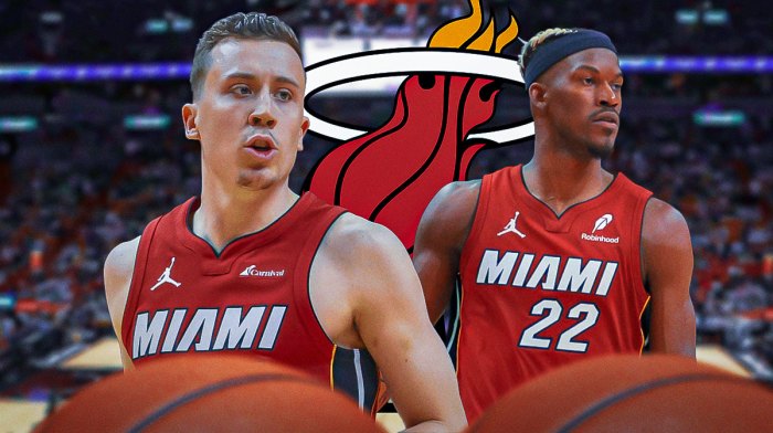 Heat forward Duncan Robinson next to former Heat forward Jimmy Butler with the Heat logo in the background