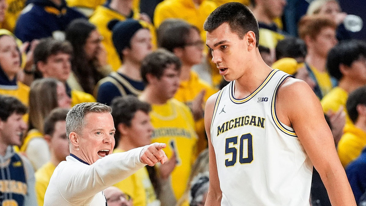 Michigan head coach Dusty May, left, talks to center Vladislav Goldin (50) during the second half against Purdue at Crisler Center in Ann Arbor on Tuesday, Feb. 11, 2025.