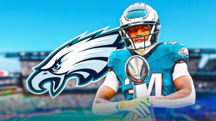 Isaiah Rodgers holding the Lombardi Trophy. Eagles logo in the background.