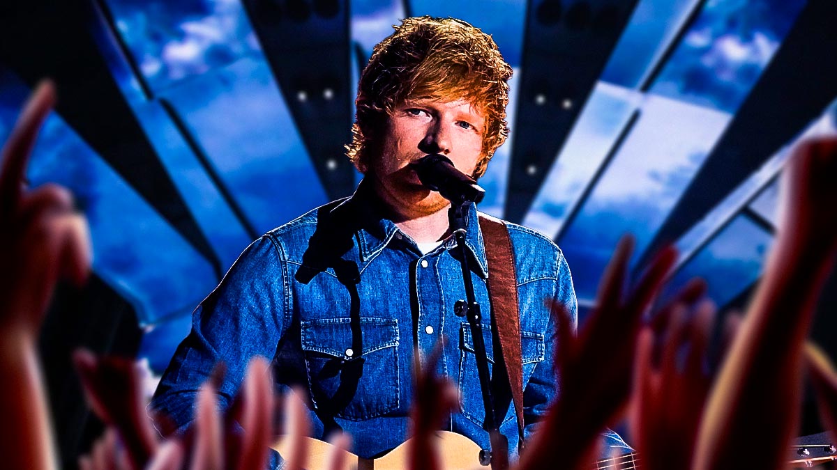 Ed Sheeran singing live on tour with concert crowd background.
