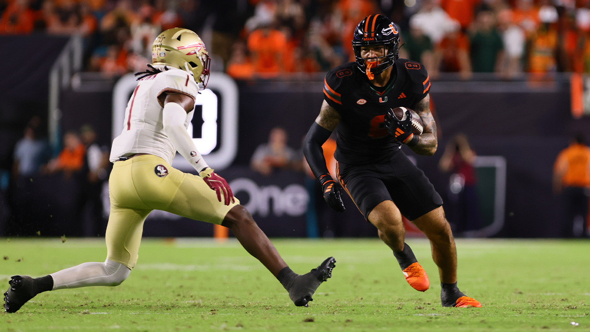 Miami Hurricanes tight end Elijah Arroyo (8) runs with the football against Florida State Seminoles defensive back Shyheim Brown (1) during the third quarter at Hard Rock Stadium