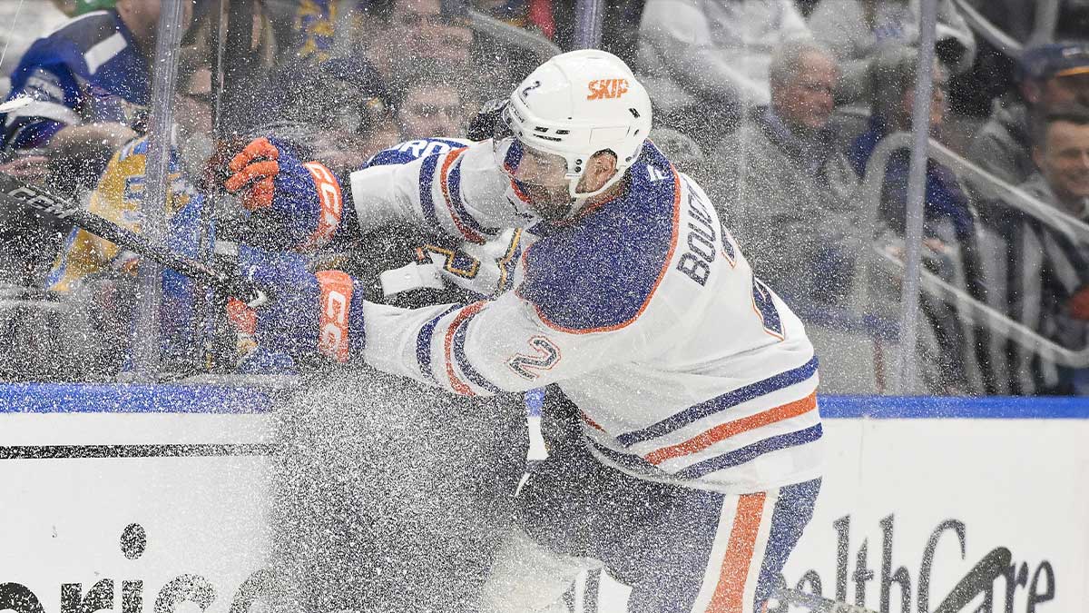 Edmonton Oilers Defenseman Evan Bouchard (2) Checks St. Louis Blues Right Wing Alexey Toropchenko (13) during the second period in Enterprise Center.