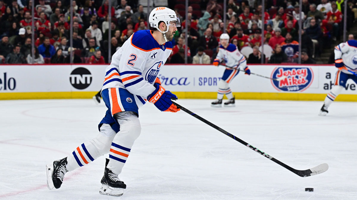 Edmonton Oilers defenseman Evan Bouchard (2) skates with the puck against the Chicago Blackhawks during the first period at the United Center. 