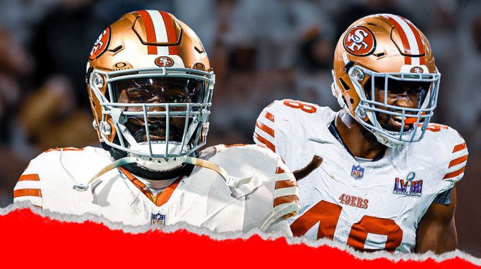 De'Vondre Campbell next to Oren Burks on the 49ers field.