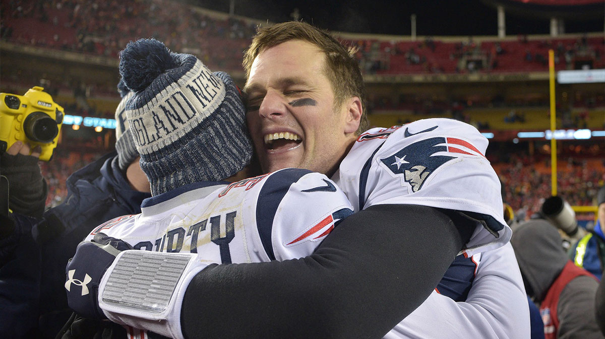 New England Patriots quarterback Tom Brady (12) celebrates with Patriots free safety Devin McCourty (32) after defeating the Kansas City Chiefs during overtime in the AFC Championship game at Arrowhead Stadium.