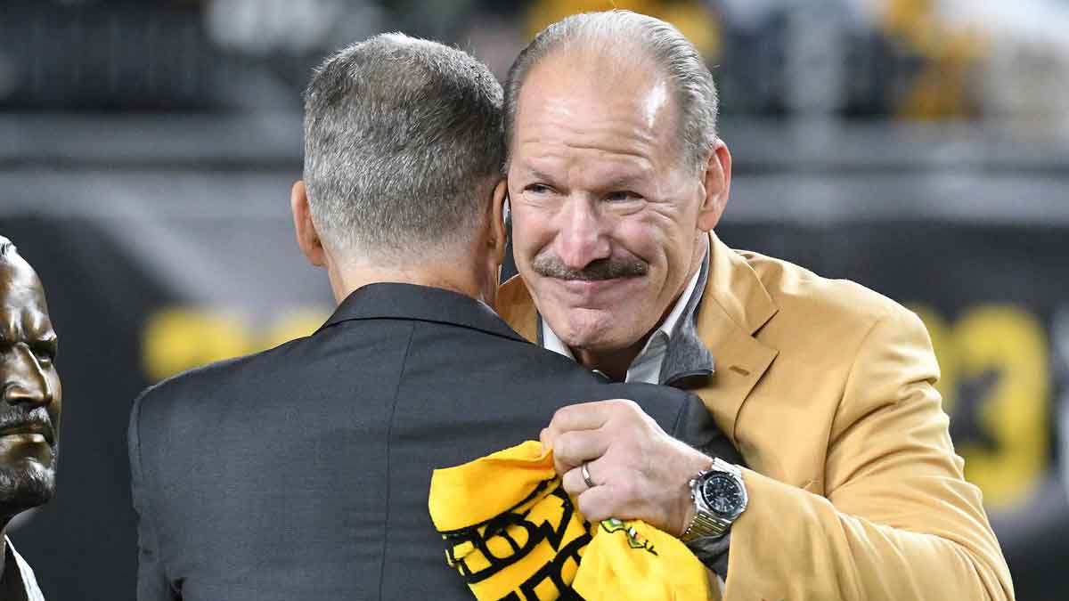 Pittsburgh Steelers head coach Bill Cowher (right) embraces team President Art Rooney II during halftime against the Seattle Seahawks at Heinz Field. Cowher was recognized for his induction into the Pro Football Hall of Fame.
