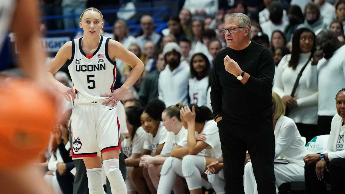 UConn Huskies head coach Geno Auriemma talks with guard Paige Bueckers (5) from the sideline as they take on the USC Trojans at XL Center.