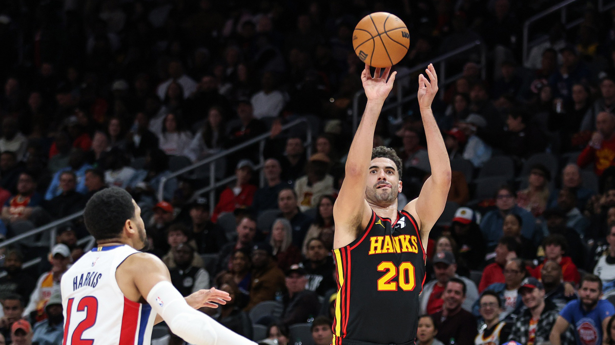 Atlanta Hawks forward Georges Niang (20) attempts three-point shot against Detroit Pistons forward Tobias Harris (12) during the third quarter at State Farm Arena. 