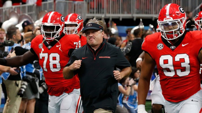 Georgia coach Kirby Smart leads his team onto the field before the start of the NCAA Aflac Kickoff Game