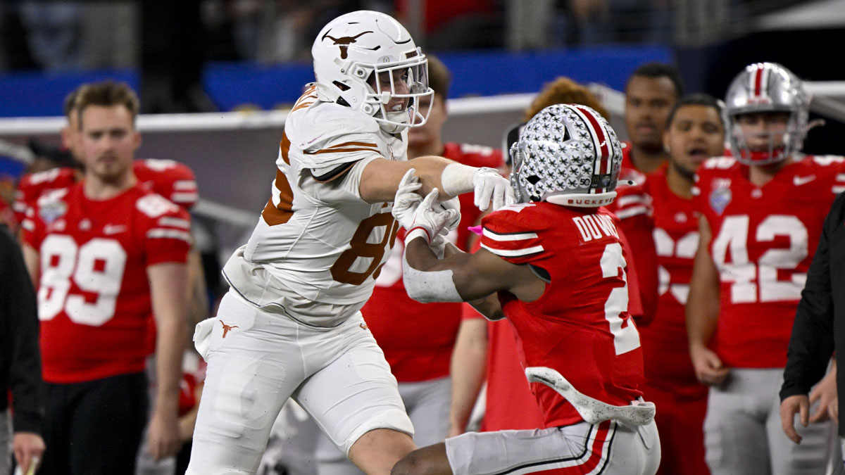 Jan 10, 2025; Arlington, TX, USA; Texas Longhorns tight end Gunnar Helm (85) shoves Ohio State Buckeyes safety Caleb Downs (2) and draws a penalty during the game between the Texas Longhorns and the Ohio State Buckeyes at AT&T Stadium. Mandatory Credit: Jerome Miron-Imagn Images