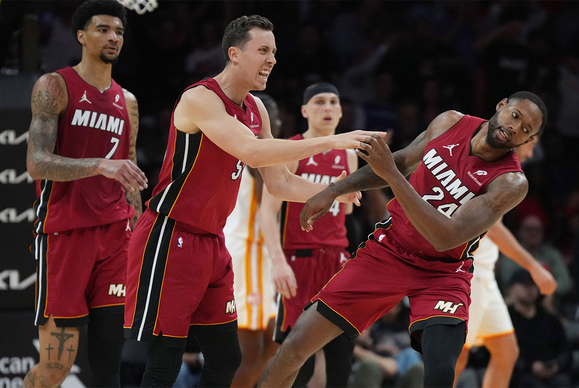 Miami Heat forward Duncan Robinson (55) playfully pushes forward Haywood Highsmith (24) following his assist on a three-point shot by Robinson that forced a timeout by the Atlanta Hawks in the second half at Kaseya Center.