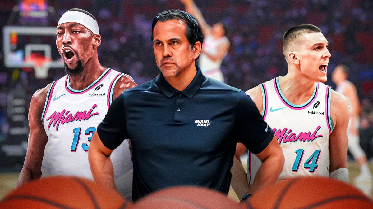 Miami Heat head coach Erik Spoelstra in the middle with Tyler Herro and Bam Adebayo on either side in front of Kaseya Center.