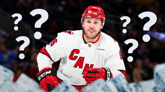 Mikko Rantanen in image looking stern (Carolina Hurricanes jersey), 3-5 question marks, money in image, hockey rink in background