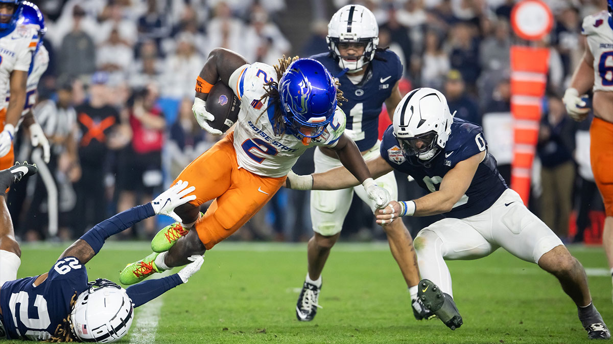 Boise State Broncos running back Ashton Jeanty (2) is tackled by Penn State Nittany Lions linebacker Dominic DeLuca (0) and cornerback Audavion Collins (29) during the Fiesta Bowl at State Farm Stadium.