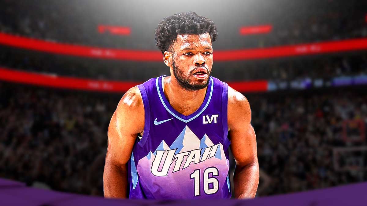 Utah Jazz player Elijah Harkless with the Utah Jazz arena in the background, G League rookie