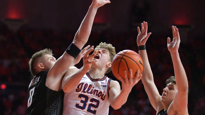 Illinois Fighting Illini guard Kasparas Jakucionis (32) drives to the basket against Michigan State Spartans forward Jaxon Kohler (0) and Szymon Zapala (10) during the first half at State Farm Center.