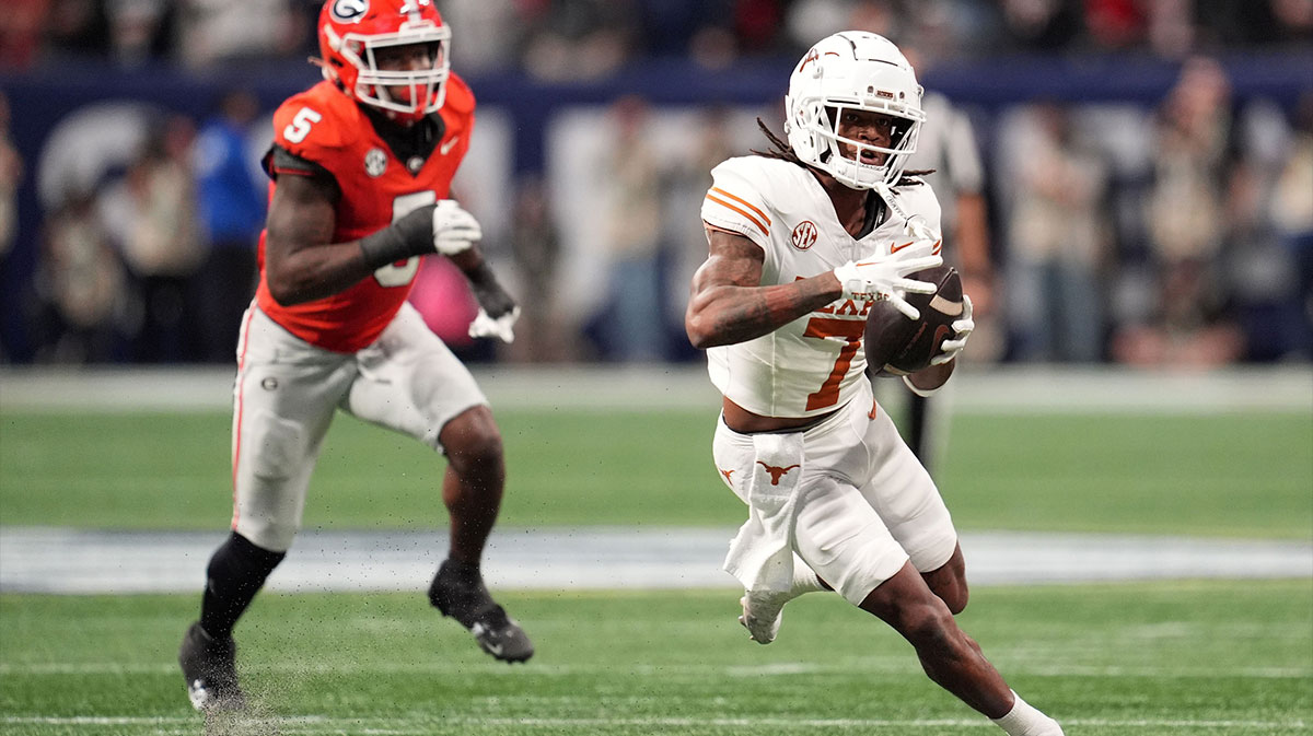 Dec 7, 2024; Atlanta, GA, USA; Texas Longhorns wide receiver Isaiah Bond (7) makes a catch past Georgia Bulldogs linebacker Raylen Wilson (5) during the first half in the 2024 SEC Championship game at Mercedes-Benz Stadium.