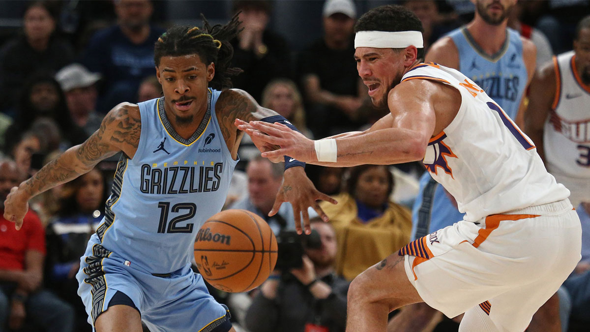 Memphis Grizzlies guard Ja Morant (12) steals the ball from Phoenix Suns guard Devin Booker (1) during the second quarter at FedExForum.