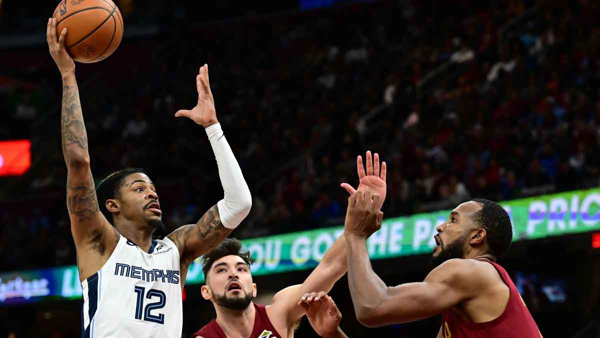 Memphis Grizzlies guard Ja Morant (12) drives to the basket against Cleveland Cavaliers guard Ty Jerome (2) and forward Evan Mobley (4) during the second half at Rocket Arena.