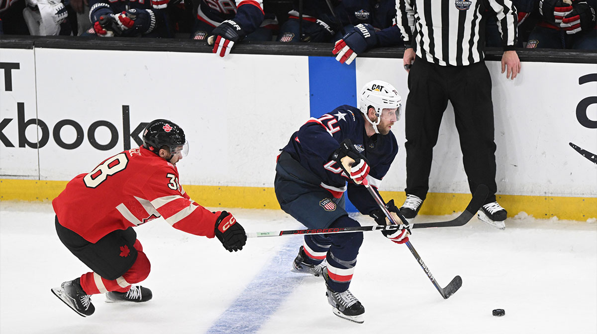 Team USA defenseman Jaccob Slavin (74) skates with the puck against Team Canada forward Brandon Hagel (38) during the third period during the 4 Nations Face-Off ice hockey championship game at TD Garden.