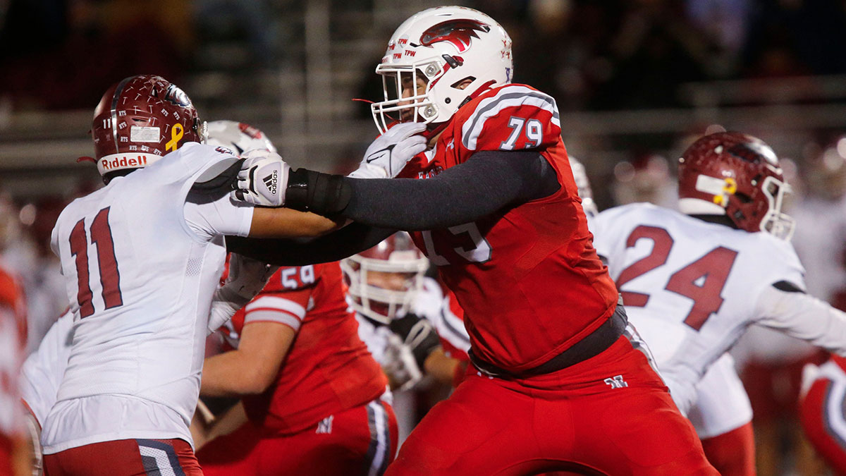 Nixa Eagles Jackson Cantwell holds back a Joplin defender during the championship game of Class 6 District 5 football