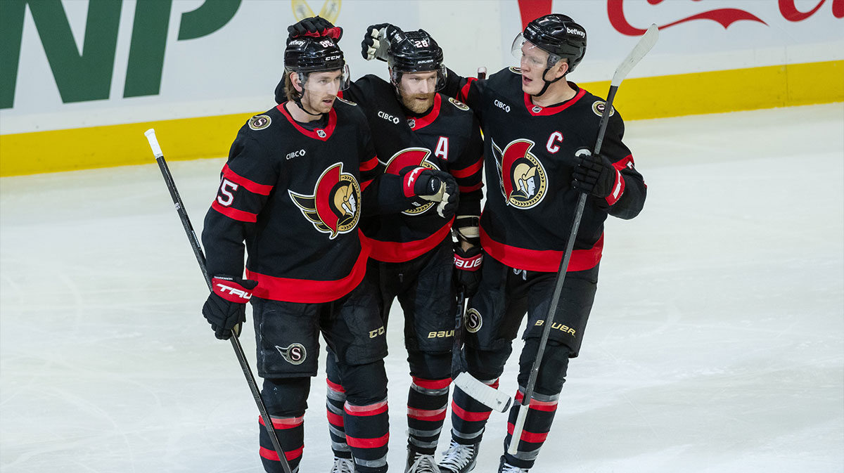 Ottawa Senators defenseman Jake Sanderson (85) is celebrated by right wing Claude Giroux (28) and left wing Brady Tkachuk (7) for his goal scored in the third period against the Washington Capitals at the Canadian Tire Centre