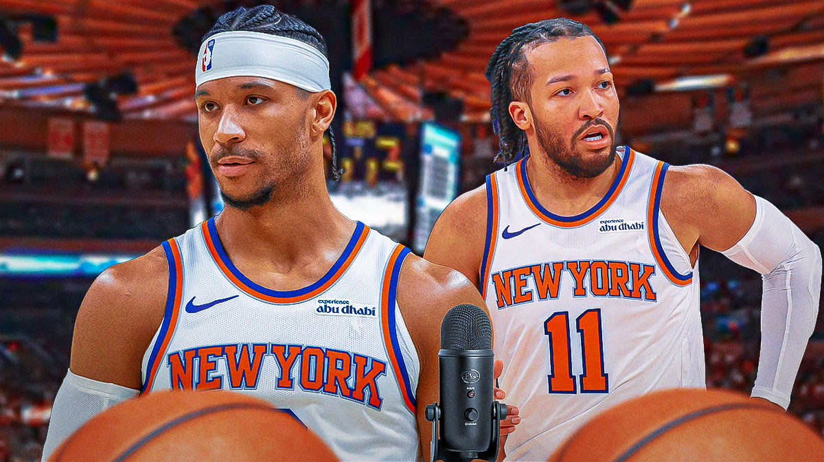 Knicks Jalen Brunson, Josh Hart straight-faced (not smiling or making any emotional expressions) with microphones in front of them and Knicks Madison Square Garden behind them