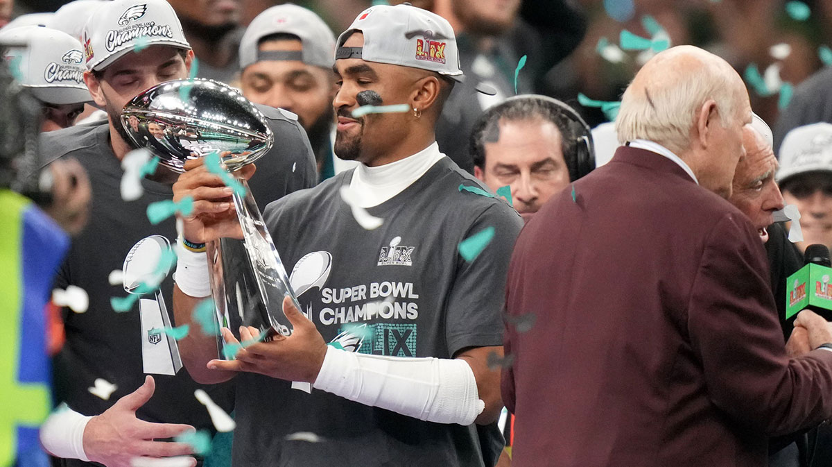 Philadelphia Eagles quarterback Jalen Hurts (1) hoists the Vince Lombardi Trophy after defeating the Kansas City Chiefs in Super Bowl LIX at Ceasars Superdome.