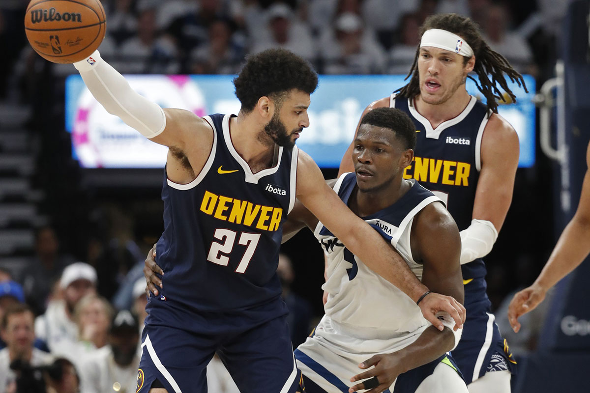 Denver Nuggets guard Jamal Murray (27) works around Minnesota Timberwolves guard Anthony Edwards (5) as forward Aaron Gordon (50) sets a pick in the third quarter of game four of the second round for the 2024 NBA playoffs at Target Center.