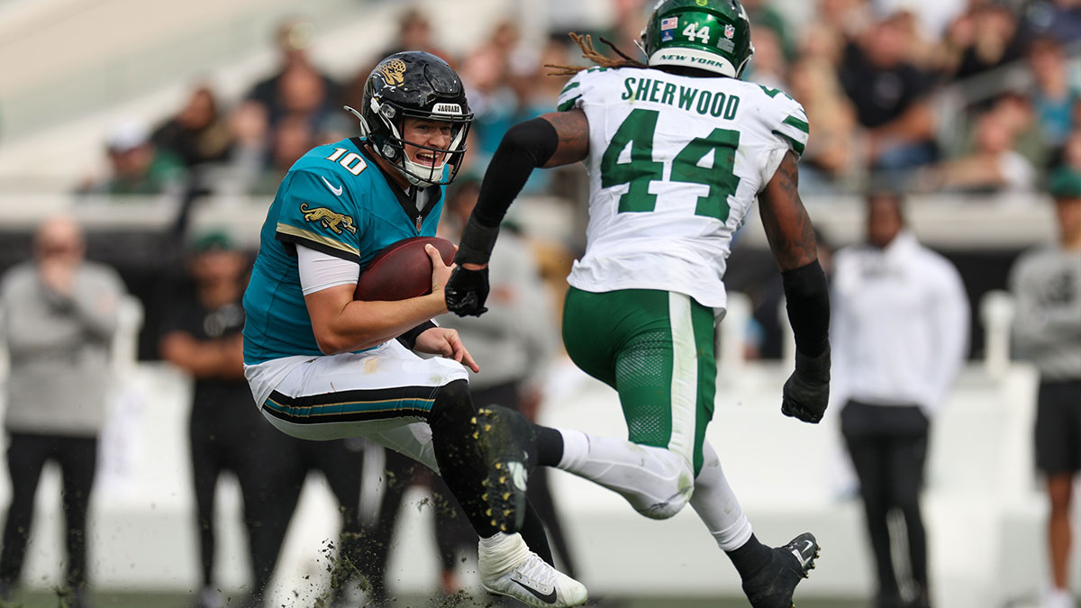 Dec 15, 2024; Jacksonville, Florida, USA; Jacksonville Jaguars quarterback Mac Jones (10) is pressured by New York Jets linebacker Jamien Sherwood (44) in the second quarter at EverBank Stadium. 