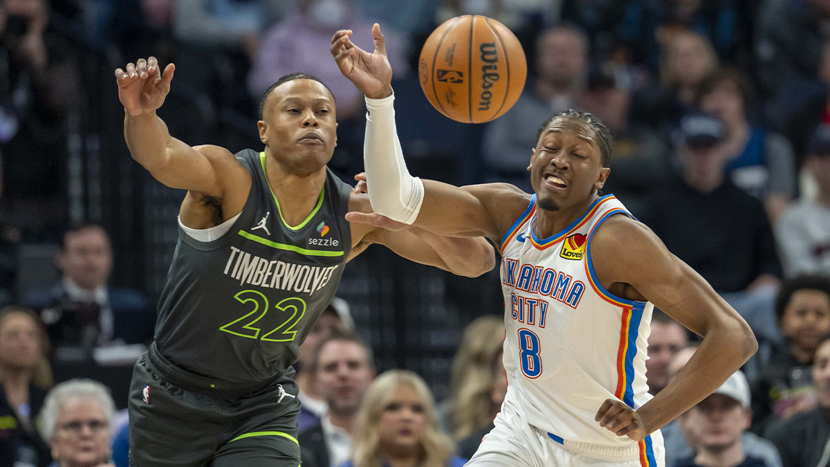 Minnesota Timberwolves guard Jaylen Clark (22) and Oklahoma City Thunder forward Jalen Williams (8) go after a loose ball in the first half at Target Center.