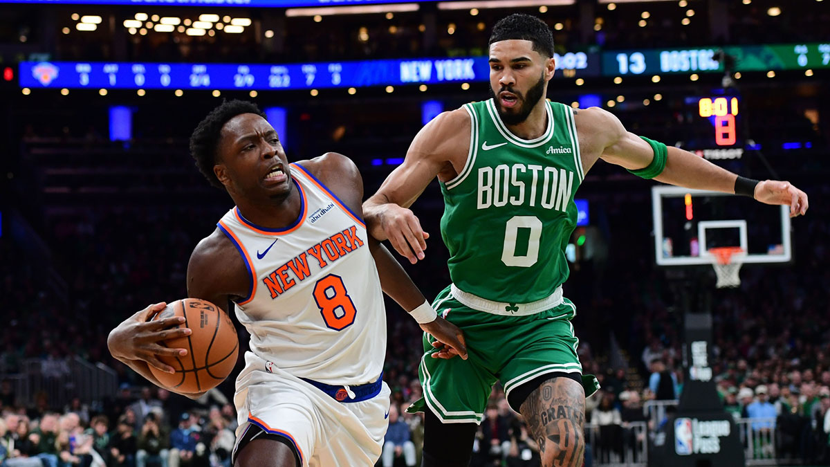 New York Knicks forward OG Anunoby (8) drives to the basket while Boston Celtics forward Jayson Tatum (0) defends during the first half at TD Garden.