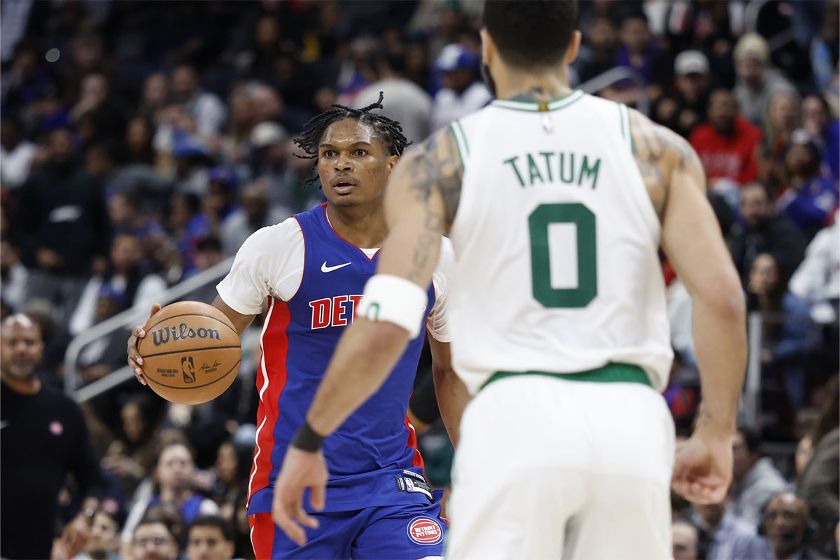 Detroit Pistons guard Marcus Sasser (25) dribbles while being defended by Boston Celtics forward Jayson Tatum (0) in the second half at Little Caesars Arena. 