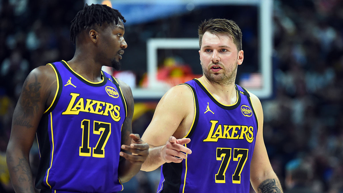 Los Angeles Lakers guard Luka Doncic (77) talks with forward Dorian Finney-Smith (17) during the second half against the Denver Nuggets at Ball Arena.