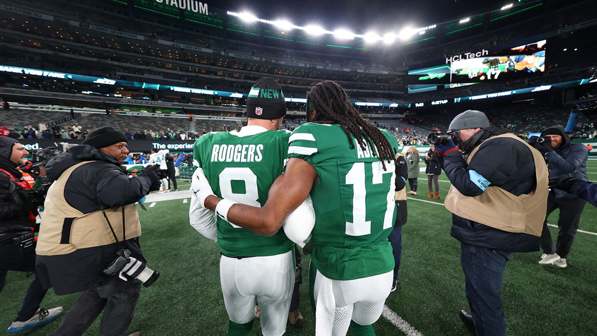 New York Jets quarterback Aaron Rodgers (8) and wide receiver Davante Adams (17) walk on the field after the Jets win over the Miami Dolphins at MetLife Stadium.