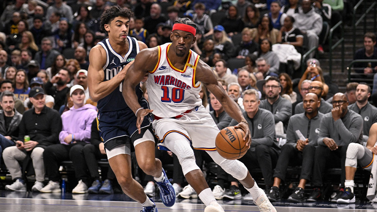 Dallas Mavericks guard Max Christie (00) and Golden State Warriors forward Jimmy Butler (10) in action during the game between the Dallas Mavericks and the Golden State Warriors at the American Airlines Center.