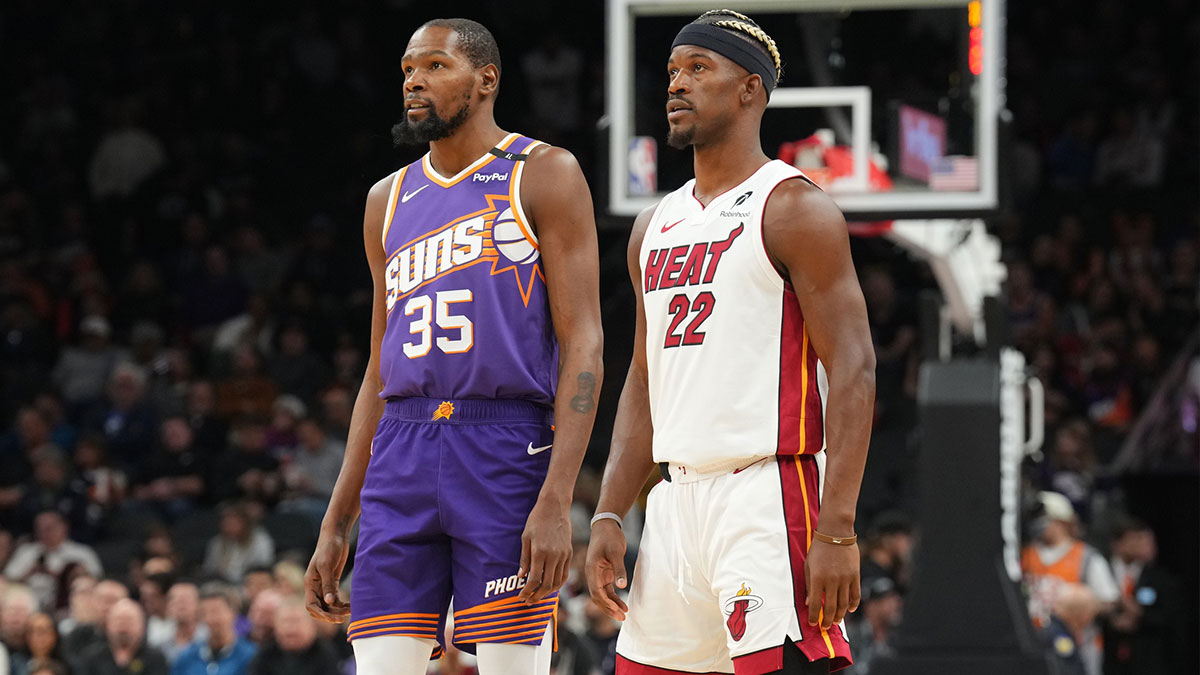 The Phoenix SUNS KEVIN striker during (35) and the striker of Miami Heat Jimmy Butler (22) watch during the first half at Footprint Center.