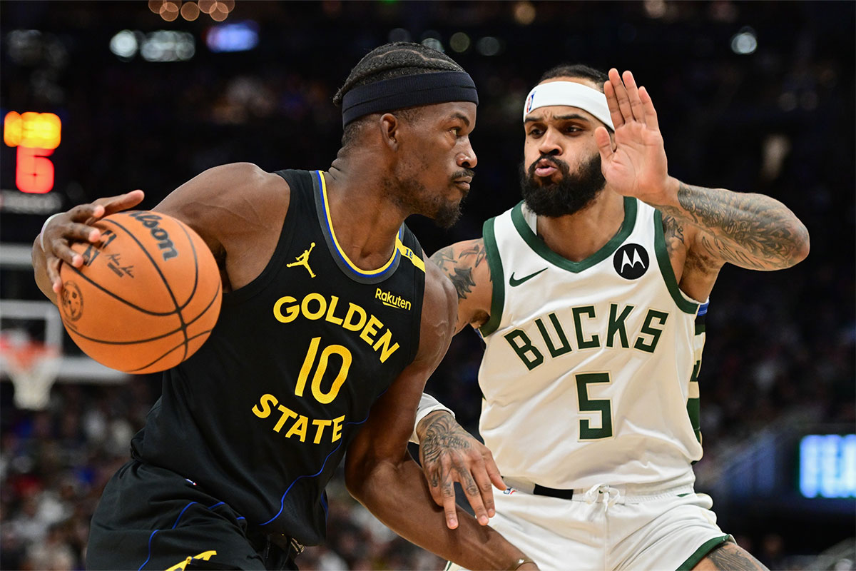 Gold State Warriors Forward Jimmy Butler (10) Cart drives against Milvaukee Bucks Guard Gary Trent Jr. (5) In the first quarter at Fiserv Forum.