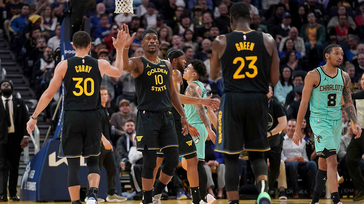 Golden State Warriors forward Jimmy Butler III (10) is congratulated by guard Stephen Curry (30) after a basket against the Charlotte Hornets in the third quarter at the Chase Center.