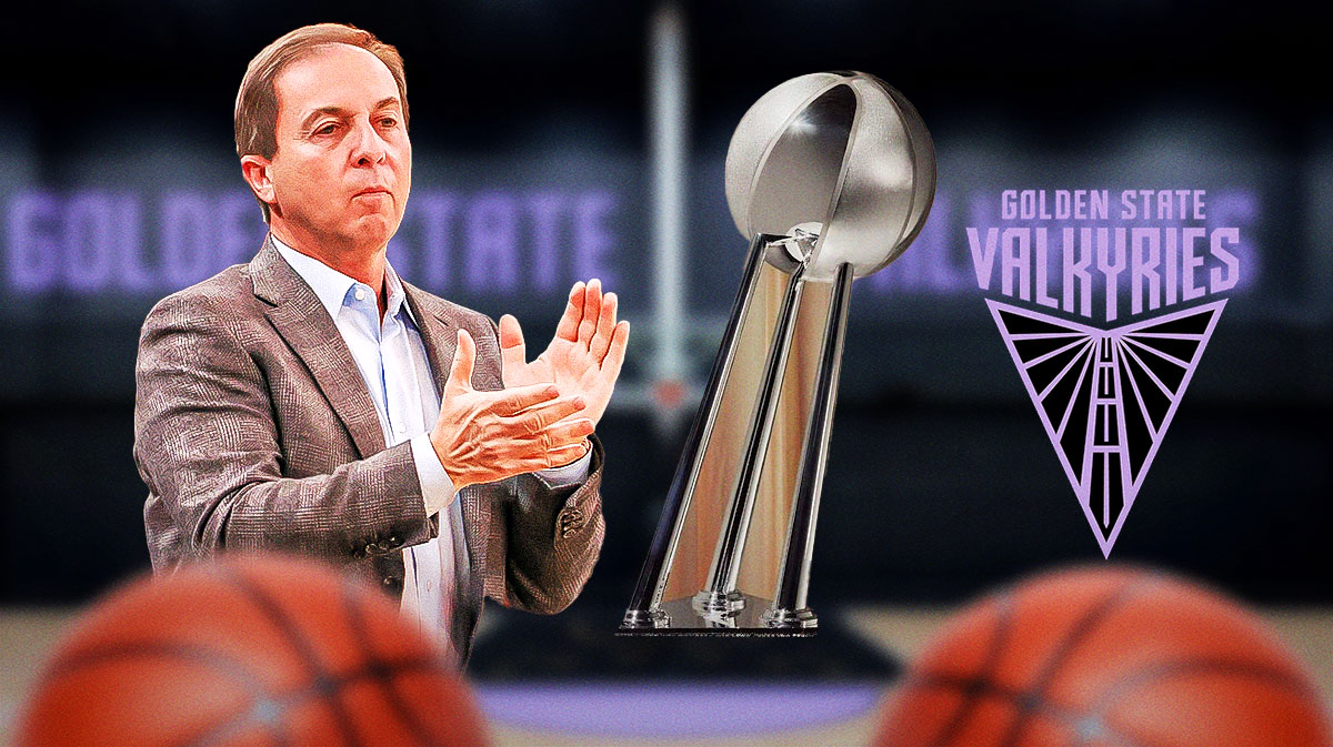 Joe Lacob with the WNBA championship trophy and the Valkyries logo in the background.