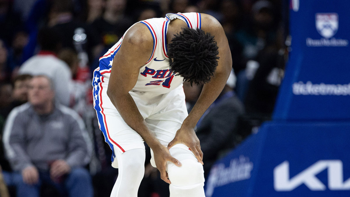 Philadelphia 76ers center Joel Embiid (21) holds his leg after a play against the Brooklyn Nets during the second quarter at Wells Fargo Center.